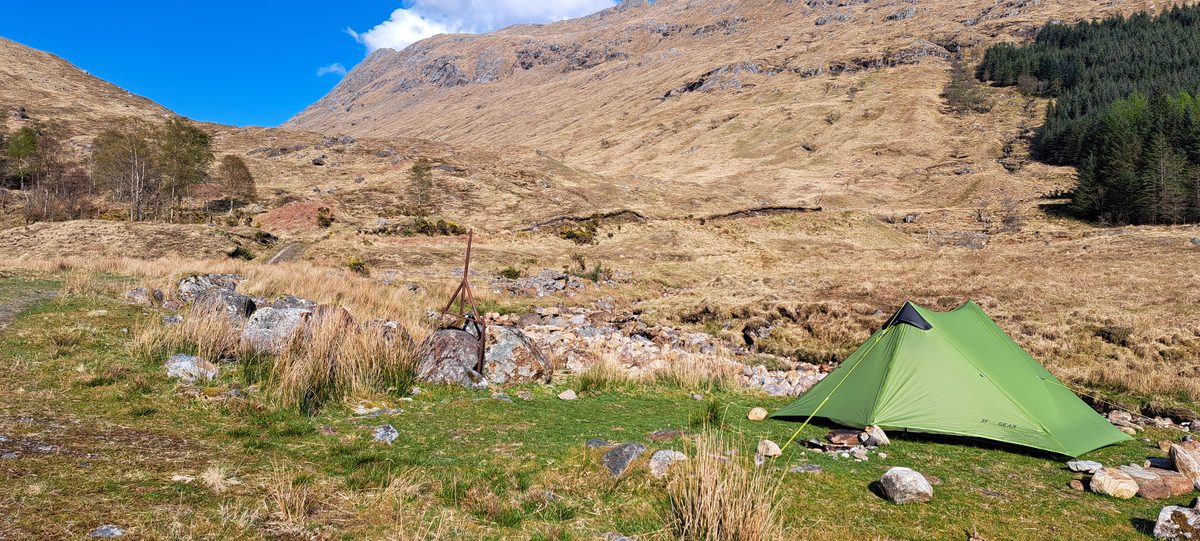 Tent pitched in a sunny Highland valley