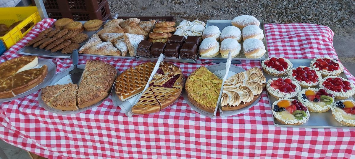 A table laid with treats and snacks at a nature campsite on the Pieterpad