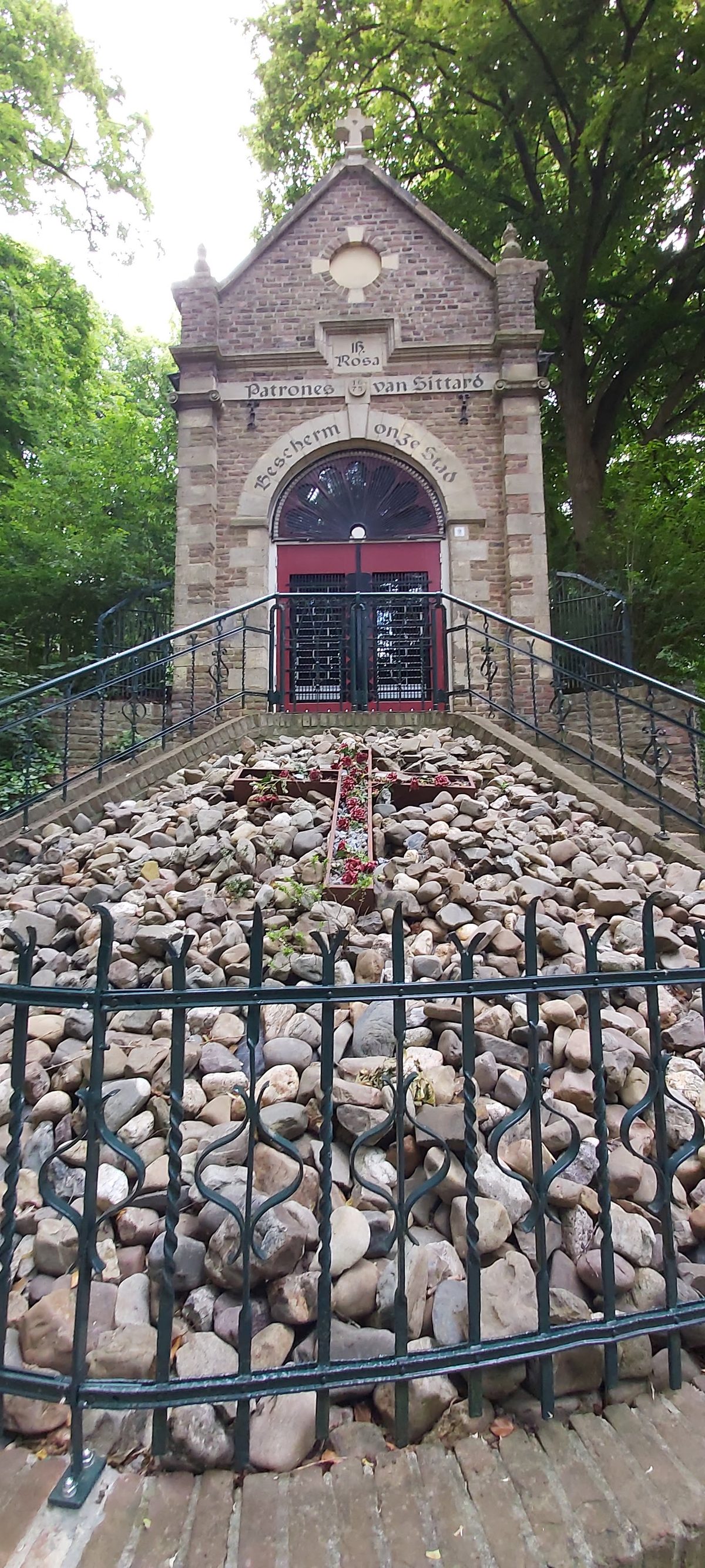 A small brick chapel with a stone staircase in the south of the Netherlands on the Pieterpad
